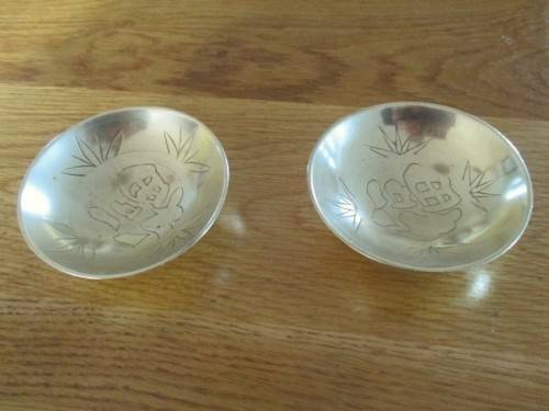 TWO SMALL VINTAGE CHINESE BRASS BOWLS/DISHES WITH GOOD LUCK SYMBOLS (PLEASE DISREGARD REFLECTIONS)