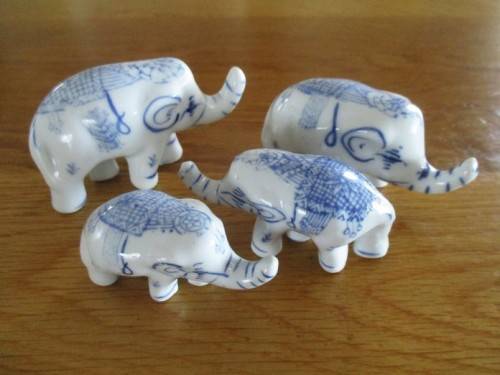 FOUR VERY CUTE AND ORNATE BLUE AND WHITE PORCELAIN ELEPHANTS