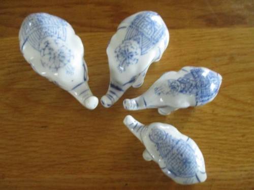 FOUR VERY CUTE AND ORNATE BLUE AND WHITE PORCELAIN ELEPHANTS
