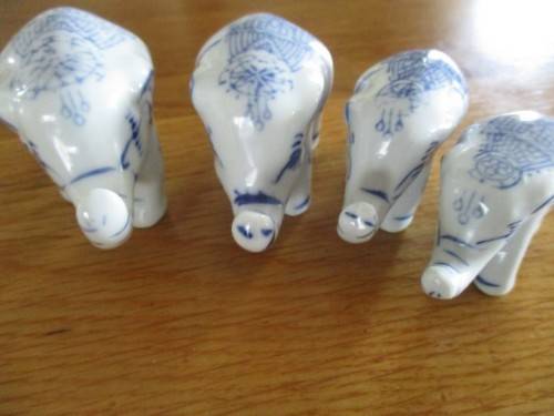 FOUR VERY CUTE AND ORNATE BLUE AND WHITE PORCELAIN ELEPHANTS