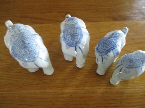 FOUR VERY CUTE AND ORNATE BLUE AND WHITE PORCELAIN ELEPHANTS