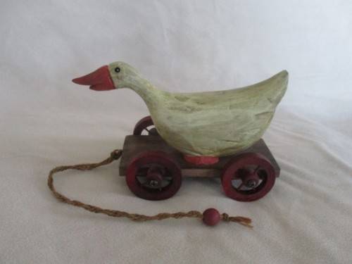 A VERY OLD VINTAGE PULL ALONG WOODEN DUCK