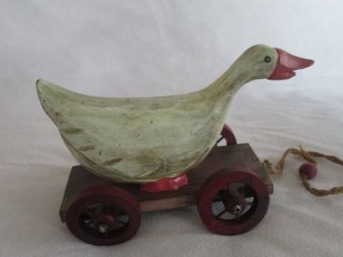 A VERY OLD VINTAGE PULL ALONG WOODEN DUCK