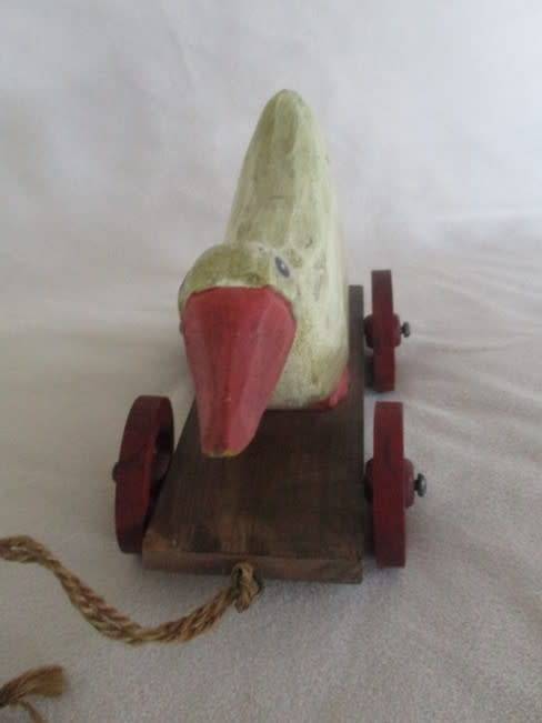 A VERY OLD VINTAGE PULL ALONG WOODEN DUCK