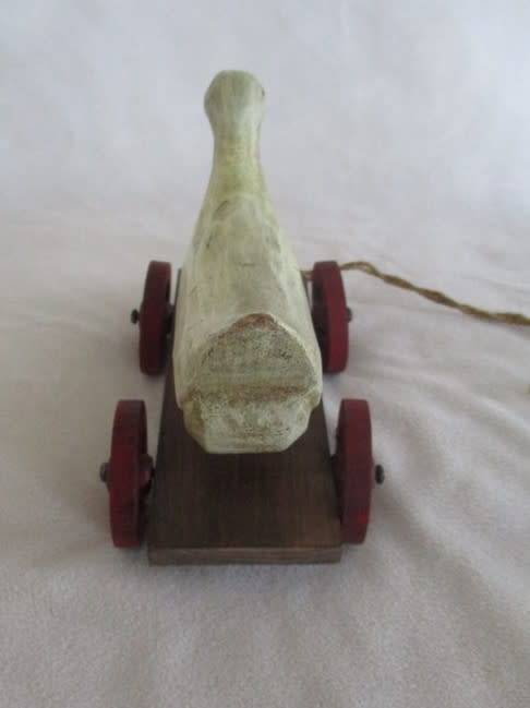 A VERY OLD VINTAGE PULL ALONG WOODEN DUCK