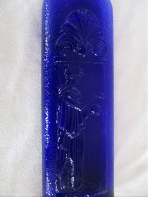 A TALL, UNUSUAL VINTAGE BLUE BOTTLE DEPICTING GRECIAN LADY