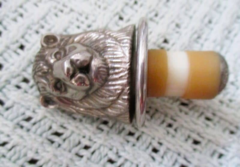 Handy bar items - two ornate metal bottle stoppers and a corkscrew