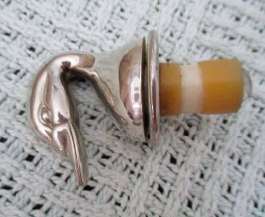 Handy bar items - two ornate metal bottle stoppers and a corkscrew