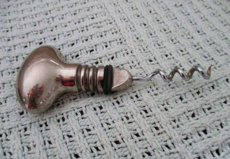 Handy bar items - two ornate metal bottle stoppers and a corkscrew