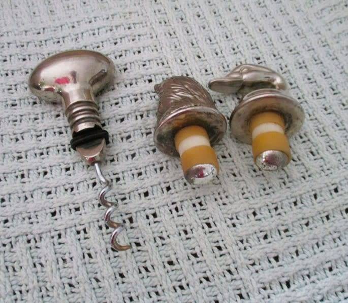 Handy bar items - two ornate metal bottle stoppers and a corkscrew