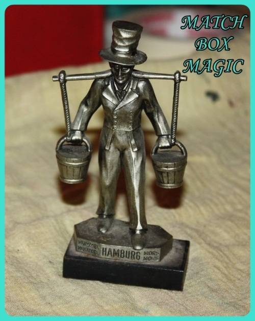 METAL STATUETTE MAN CARRYING BUCKETS HAMBURG ON BASE