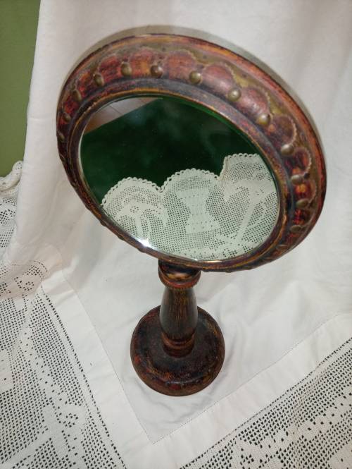 Upright wooden shaving mirror with metalwork decorative detail