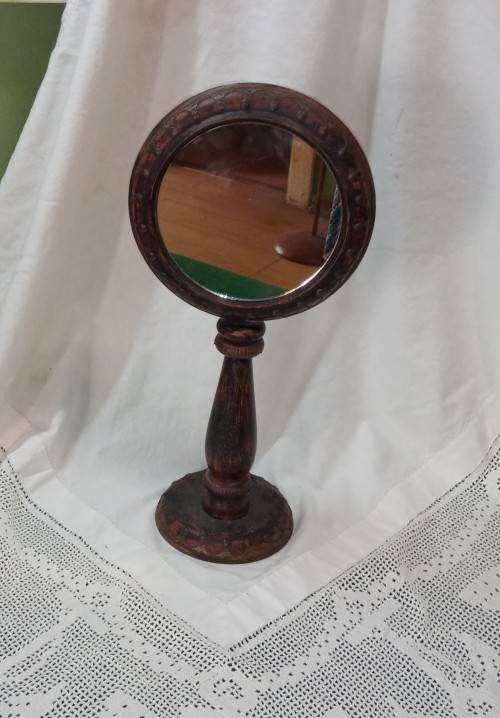 Upright wooden shaving mirror with metalwork decorative detail