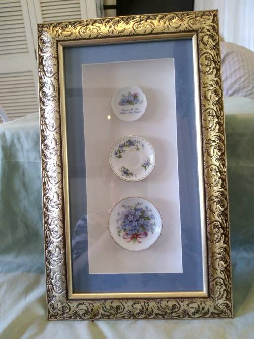 Beautifully framed trio of forget-me-not porcelain pin plates