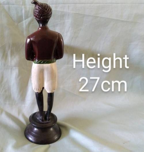 Decorative metal statuette of man holding a bowl