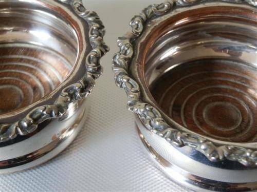 Pair of Victorian Silver Plate on Copper Coasters with Turned Wooden Basis.