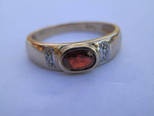 9 ct Gold garnet and diamond ring. Two (2) weeks to pay