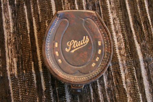 Studs Leather holder filled with several pairs of Studs and cufflinks