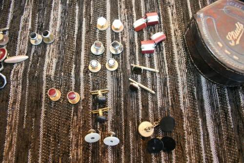 Studs Leather holder filled with several pairs of Studs and cufflinks