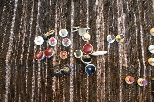 Studs Leather holder filled with several pairs of Studs and cufflinks