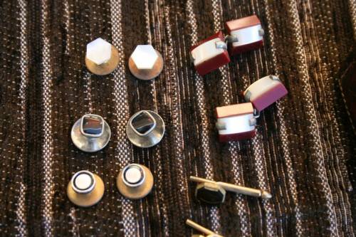 Studs Leather holder filled with several pairs of Studs and cufflinks