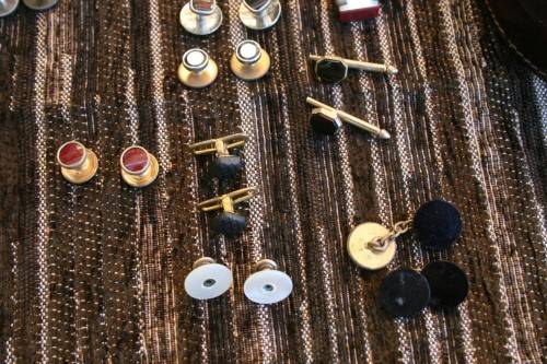 Studs Leather holder filled with several pairs of Studs and cufflinks