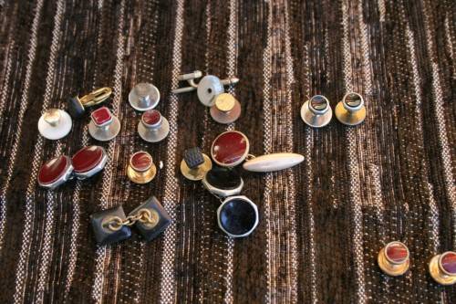 Studs Leather holder filled with several pairs of Studs and cufflinks