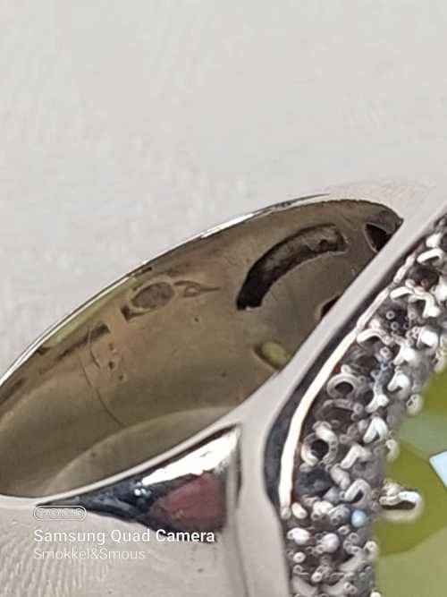 Sterling silver ladies ring with very large green stone surrounded with cubic zirconia Size: M.5