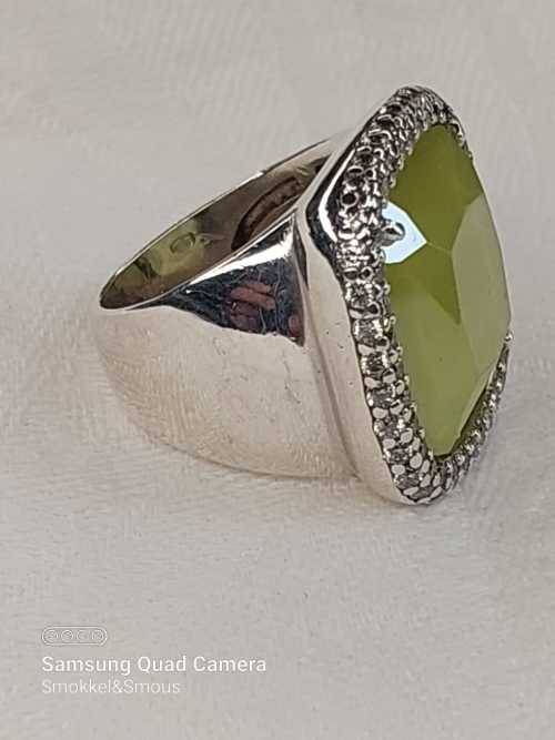 Sterling silver ladies ring with very large green stone surrounded with cubic zirconia Size: M.5