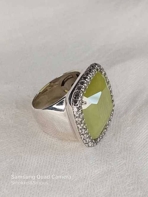 Sterling silver ladies ring with very large green stone surrounded with cubic zirconia Size: M.5