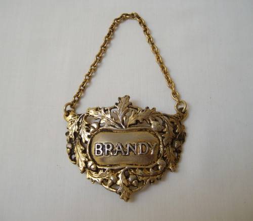 VINTAGE BRASS-PLATED BRANDY DECANTER LABEL