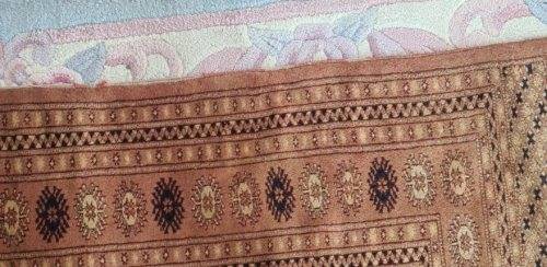 Slightly worn Persian carpet