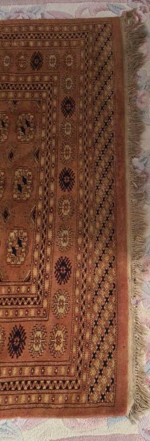 Slightly worn Persian carpet