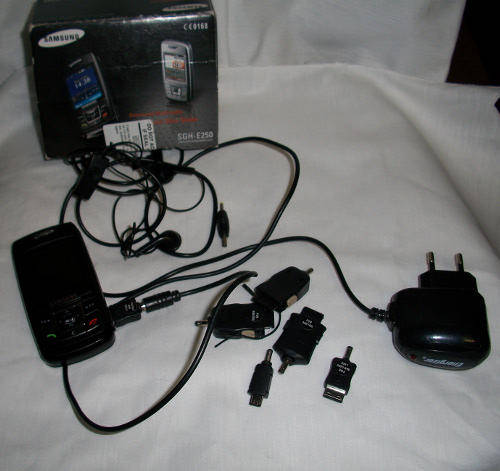 Samsung phone plus a collection of samsung interchangebale charger parts.