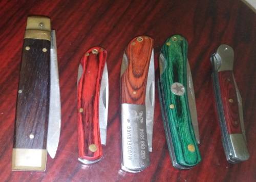 A Collection of 5 Folding Knives with Wooden Handles