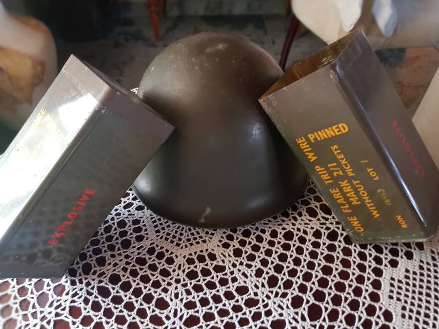 ARMY HELMET AND EXPLOSIVE CANISTERS