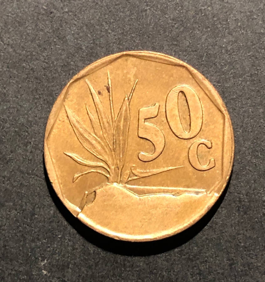 SPECTACULAR MINT ERROR - MAJOR DIE BREAK ON COPPER 50c COIN!