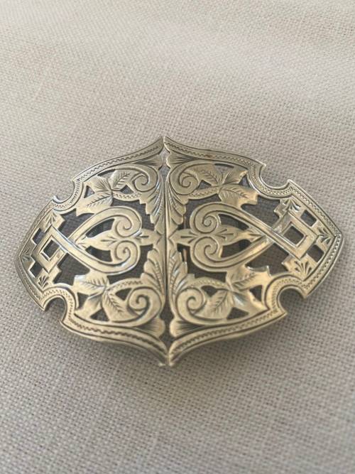 SILVER BUCKLE has markings anchor rampant with tail in air and a c