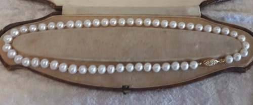 Strand of matched 8 mm fresh water pearls with sterling silver gilt clasp