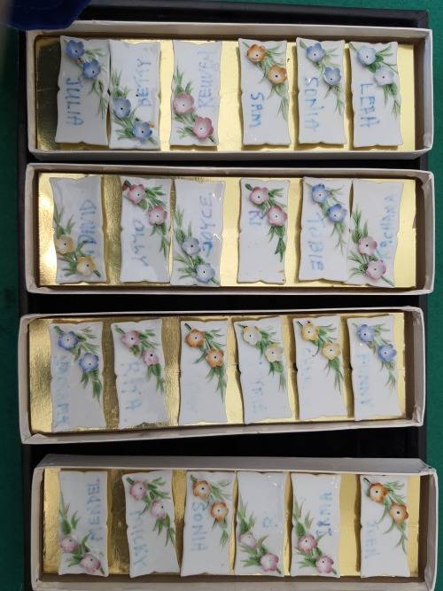 4 sets of 6 each in a box Nameplates made of porcelain and floral decorated