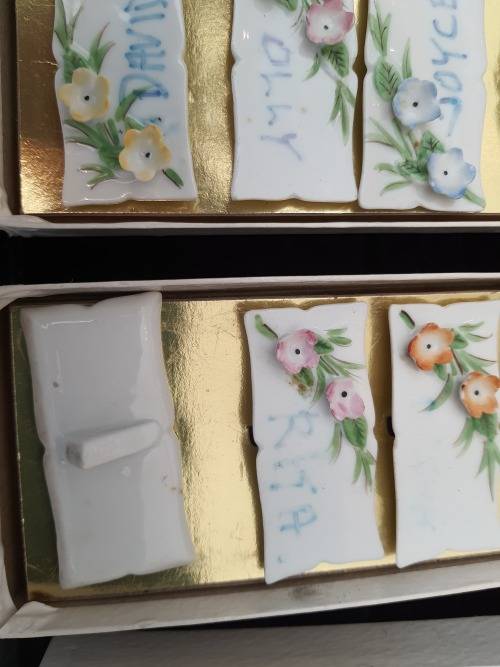 4 sets of 6 each in a box Nameplates made of porcelain and floral decorated