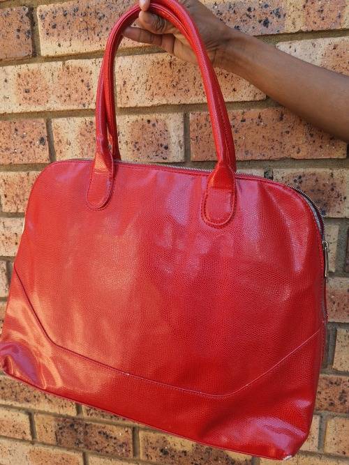 A RED TOTE HAND BAG MADE BY BARON