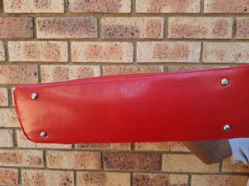 A RED TOTE HAND BAG MADE BY BARON