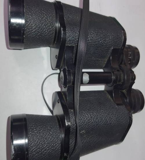 A VINTAGE BINOCULARS SOLD AS IS