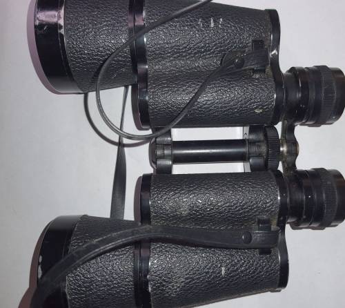 A VINTAGE BINOCULARS SOLD AS IS