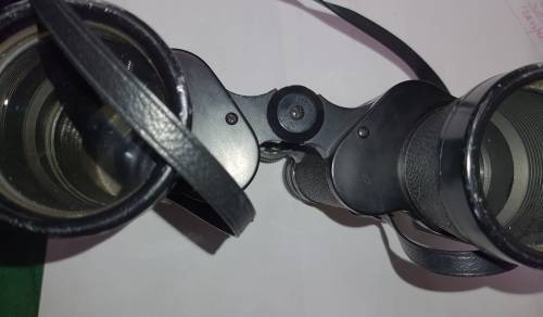 A VINTAGE BINOCULARS SOLD AS IS