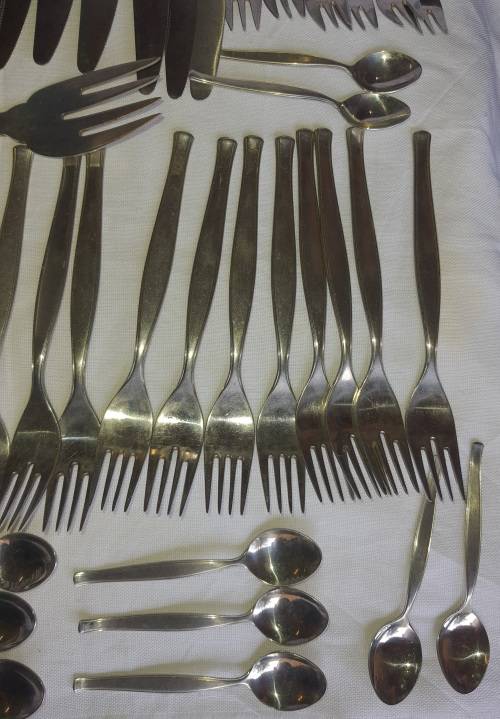 A VINTAGE STAINLESS STELL CUTTLERY SET SOLD AS IS