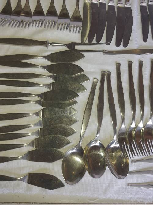 A VINTAGE STAINLESS STELL CUTTLERY SET SOLD AS IS