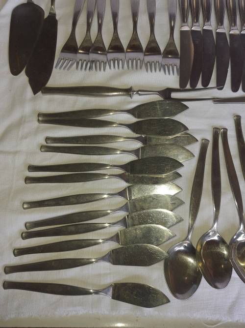 A VINTAGE STAINLESS STELL CUTTLERY SET SOLD AS IS