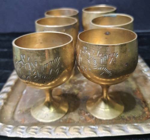 A  VINTAGE SET OF SHERRY BRASS SHOT INGOTS AND A TRAY
